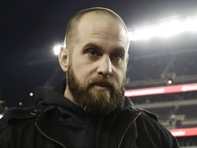 FILE - In this Dec. 22, 2016, file photo, then-injured Philadelphia Eagles' Jon Dorenbos walks the sidelines before an NFL football game against the New York Giants, in Philadelphia.  Saints coach Sean Payton says long snapper Jon Dorenbos has a "serious" heart condition that will require surgery. Payton, who spoke about Dorenbos on a media conference call Friday morning, Sept. 8, 2017, says Saints physician John Amoss discovered he long-snapper's aortic aneurysm during a physical examination and "basically saved his life." Dorenbos, who was entering his 15th NFL season, was acquired in a trade with Philadelphia before the Saints final preseason game. (AP Photo/Michael Perez, File)