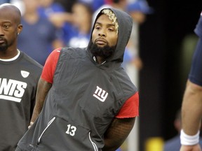 FILE - In this Aug. 31, 2017, file photo, New York Giants wide receiver Odell Beckham watches his teammates warm up before an NFL preseason football game against the New England Patriots, in Foxborough, Mass. Beckham Jr. has been listed as questionable for the Giants' season opener against the Cowboys in Dallas on Sunday night. Questionable in NFL terminology is a 50-50 chance to play.(AP Photo/Steven Senne, File)