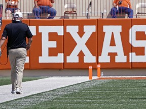 FILE - In this Sept. 2, 2017, file photo, Texas head coach Tom Herman walks the sideline during the first half of a 51-41 loss in an NCAA college football game against Maryland,  in Austin, Texas. West Virginia and Texas, both in the Top 25 to start this season, lost the Big 12's only opening-weekend games against other Power Five leagues. (AP Photo/Michael Thomas, File)