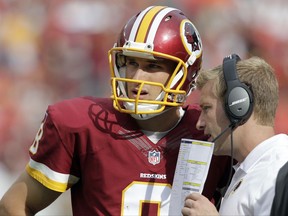 FILE - In this Sunday, Sept. 14, 2014 file photo, Washington Redskins quarterback Kirk Cousins (8) listens to offensive coordinator Sean McVay, during the second half of an NFL football game against the Jacksonville Jaguars in Landover, Md. Redskins quarterback Kirk Cousins will try to rebound from a rough season opener against Sean McVay, his former offensive coordinator who knows him better than most people in the NFL. Cousins on Sunday, Sept. 17, 2017 will face former offensive coordinator Sean McVay's Los Angeles Rams as the Redskins hope to avoid starting 0-2.  (AP Photo/Mark E. Tenally, File)