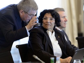 FILE - In this March 2, 2016, file photo, International Olympic Committee (IOC) president Thomas Bach, of Germany, left, speaks with IOC member Anita DeFrantz, of the United States, right, at an IOC executive board meeting in Lausanne, Switzerland. DeFrantz, a bronze medalist in rowing at the 1976 Olympic, has won her second term as vice president of the International Olympic Committee on Friday, Sept. 15, 2017. (Laurent Gillieron/Keystone via AP, File)