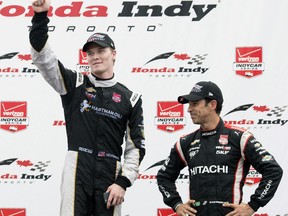 FILE - In this June 14, 2015, file photo, winner Josef Newgarden, left, and teammate and third place Helio Castroneves celebrate on the posium after the Honda Toronto IndyCar race in Toronto. As NASCAR prepares to open its playoffs, the IndyCar Series is ready to crown its champion. Four drivers go into the season finale Sunday at Sonoma Raceway in contention for the title, which is a Penske vs. Ganassi showdown. Josef Newgarden holds a three-point lead in the standings over Ganassi driver Scott Dixon. Newgarden's two Penske teammates are also in striking distance. (Darren Calabrese/The Canadian Press via AP, File)