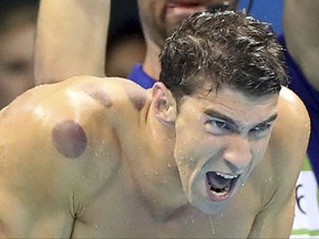 FILE - In this Aug. 7, 2016, file photo United States swimmer Michael Phelps encourages his teammates in the final of the men's 4x100-meter freestyle relay during the swimming competitions at the 2016 Summer Olympics in Rio de Janeiro, Brazil. Phelps says he has "no desire" to return to competitive swimming, but he's eager to stay involved with the sport and cheer on those who follow in his enormous wake.  (AP Photo/Lee Jin-man, File)
