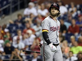 FILE - In this Tuesday, Sept. 26, 2017, file photo, Washington Nationals' Bryce Harper heads to the dugout during a baseball game against the Philadelphia Phillies in Philadelphia. Harper was out of the starting  lineup for Washington's game against the Pittsburgh Pirates on Thursday, Sept. 28, 2017,  because he was feeling sore. Harper returned to the team on Tuesday  after  missing 42 games with a knee injury. (AP Photo/Matt Slocum, File)