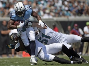 FILE - In this Sunday, Sept. 17, 2017, file photo, Tennessee Titans running back DeMarco Murray (29) is stopped by Jacksonville Jaguars outside linebacker Myles Jack, left, and middle linebacker Paul Posluszny (51) during the first half of an NFL football game in Jacksonville, Fla. Murray, who has missed two straight practices, is expected back on the field Friday before Tennessee hosts Seattle on Sunday. (AP Photo/Phelan M. Ebenhack, File)