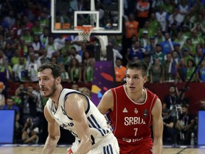 FILE - In this Sept. 17. 2017, file photo, Slovenia's Goran Dragic, left, drives to the basket as Serbia's Bogdan Bogdanovic tries to block him during their Eurobasket European Basketball Championship finals in Istanbul. Here's how Heat guard Goran Dragic spent his summer vacation. He led Slovenia, his mother's homeland, to an improbable gold medal at the European Championships.  (AP Photo/Lefteris Pitarakis, File)