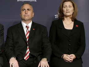 FILE - In this Dec. 10, 2013, file photo, Rutgers athletic director Julie Hermann, right, and head football coach Kyle Flood, listen during an NCAA college football news conference in New York.  The NCAA on Friday, Sept. 22, 2017, has placed Rutgers on two-year probation and publically reprimanded and censured the university for failing to monitor its football program over a five-year period between 2011 and 2015. The NCAA says Rutgers helped itself by cooperating with investigation, firing Flood and Hermann after the 2015 season, and implementing a new drug testing and hiring a new chief medical officer. (AP Photo/Seth Wenig, File)