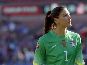 FILE - In this Feb. 13, 2016, file photo, United States goalie Hope Solo walks off the field at half time of a CONCACAF Olympic qualifying tournament soccer match against Mexico in Frisco, Texas. Solo says she's settled a grievance with U.S. Soccer over her suspension from the women's national team last year following comments she made at the Rio Olympics. (AP Photo/Tony Gutierrez, File)