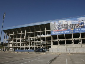 FILE - In this March 29, 2010, file photo, a student walks past Memorial Stadium at the University of Kansas in Lawrence, Kan. The university revealed, during a dinner Friday night, Sept. 22, 2017, for some of its most influential donors, a $350 million plan to overhaul its football stadium and improve other facilities. (AP Photo/Orlin Wagner, File)