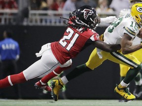 FILE - In this Sunday, Sept. 17, 2017 file photo, Green Bay Packers wide receiver Randall Cobb (18) makes the catch against Atlanta Falcons cornerback Desmond Trufant (21) during the first of an NFL football game in Atlanta. The banged-up Green Bay Packers are starting practice this week with about a dozen players on the injury report. Receivers Jordy Nelson and Randall Cobb, along with defensive lineman Mike Daniels were among the notable Packers who left last week's 34-23 loss to Atlanta with injuries. Coach Mike McCarthy spoke broadly about the injuries before practice on Wednesday, Sept. 20, 2017. (AP Photo/David Goldman, File)