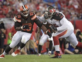 FILE - In this Aug. 26, 2017, file photo, Tampa Bay Buccaneers offensive tackle Donovan Smith (76) blocks against Cleveland Browns defensive end Myles Garrett (95) during an NFL preseason football game in Tampa, Fla. Passing on a quarterback with the No. 1 overall pick, the Browns selected Garrett, who has been better than advertised during practices and the exhibition season. Soft-spoken, hard-hitting and a frightening blend of speed and strength, Garrett gives Cleveland a bona fide threat to pressure the quarterback on every snap. (AP Photo/Phelan M. Ebenhack, File)