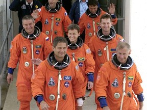 FILE - In this Wednesday June 5, 2002 file photo, Space shuttle Endeavour commander Kenneth Cockrell, right, and pilot Paul Lockhart lead the way out of crew quarters followed by, second row from left, Valeri Korzun, Peggy Whitson, and Sergei Treschev; third row from left are Philippe Perrin and Franklin Chang-Diaz at Cape Canaveral, Fla., before their launch later in the day. (AP Photo/Peter Cosgrove)