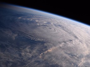 FILE - This photo made available by NASA shows Hurricane Harvey over Texas on Saturday, Aug. 26, 2017, seen from the International Space Station. Experts say a combination of unusual factors turned Harvey into a deadly monster. The storm intensified just before it hit land, parked itself over one unfortunate area and dumped a record amount of rain. (Randy Bresnik/NASA via AP)