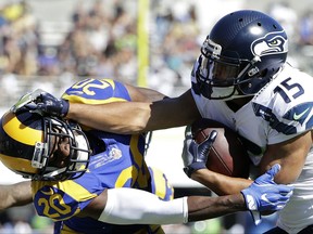FILE - In this Sept. 18, 2016, file photo, Seattle Seahawks wide receiver Jermaine Kearse, right, pushes Los Angeles Rams cornerback Lamarcus Joyner as he runs the ball during the second half of an NFL football game in Los Angeles. The Seahawks have acquired defensive tackle Sheldon Richardson from the New York Jets in exchange for Kearse and a second-round draft pick. (AP Photo/Jae Hong, File)
