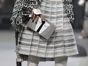 FILE - In this Wednesday, Feb. 15, 2017, file photo, the Thom Browne collection is modeled during Fashion Week, in New York. The New York fashion world gathers Wednesday, Sept. 6, to honor designer Browne with the annual Couture Council Award for Artistry of Fashion from the Fashion Institute of Technology. Browne, who regularly puts on the most fascinating, theatrically stunning shows in all of Fashion Week, won't be showing here: He's moving his women's shows to Paris, where he already shows his menswear. (AP Photo/Julie Jacobson, File)