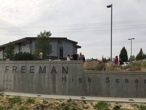 People gather outside of Freeman High School after reports of a shooting at the school in Rockford, Wash., Wednesday, Sept. 13, 2017. (KHQ via AP)