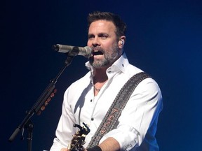 FILE - In this Jan. 17, 2013, file photo, Troy Gentry of the Country Music duo Montgomery Gentry performs on the Rebels On The Run Tour in Lancaster, Pa. Stars of the Grand Ole Opry will gather Thursday, Sept. 14, 2017, to honor country singer Gentry who died in a helicopter crash. (Photo by Owen Sweeney/Invision/AP, File)
