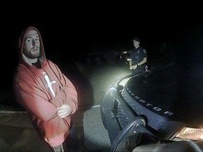 FILE - In this Sept. 3, 2017, file image made from a body camera video provided by the Stow Police Department, William Porubsky stands by Officer Robert Molody's cruiser in Stow, Ohio. Molody shot and killed Porubsky near the homeless shelter in Akron after Porubsky tackled him, according to police video footage released Thursday, Sept. 7. Friends and family of Porubsky have been wondering why he wasn't helped when they say police knew about his drug abuse and mental health issues. (Stow Police Department via AP, File)