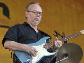 FILE - In this Sunday, May 6, 2007, file photo, Walter Becker, of Steely Dan, performs during the 2007 Jazz and Heritage Festival in New Orleans. Becker, the guitarist, bassist and co-founder of the rock group Steely Dan, has died. He was 67. His official website announced his death Sunday, Sept. 3, 2017, with no further details. (AP Photo/Dave Martin, File)