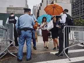 Police stop people at a check point outside the United Nations building before the arrival of President Donald Trump in New York, Monday, Sept. 18, 2017, in New York. (AP Photo/Andres Kudacki)