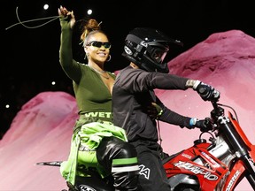 Rihanna rides on a motorcycle after showing her fashion collection from Fenty Puma by Rihanna during Fashion Week, Sunday, Sept. 10, 2017, in New York. (AP Photo/Bebeto Matthews)