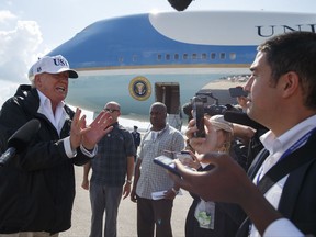 FILE - In this Thursday, Sept. 14, 2017, file photo, President Donald Trump talks with reporters after landing on Air Force One, in Fort Myers, Fla. Trump has taken a hard stand that slashing the corporate tax rate from 35 percent to as low as 15 percent would free up cash at these companies. The money would seep into worker paychecks and hiring would accelerate. "We're going to have magnificent growth," Trump declared aboard Air Force One on Thursday. "We're going to go like a rocket ship." But several economists, tax experts and even some business owners say that's unlikely. (AP Photo/Evan Vucci)