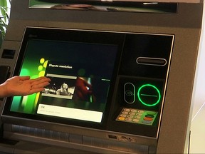 In this Monday, Aug. 14, 2017, frame grab from video, NCR briefing center manager Ksenia Bocharova demonstrates dispute resolution on NCR's newest ATM, in Duluth, Ga. 2017 marks the 50th anniversary of the ATM. Newer ATMs have more functions than ever. NCR says the latest models are designed to act more like smart devices with swiping and other features. (AP Photo/Marina Hutchinson)