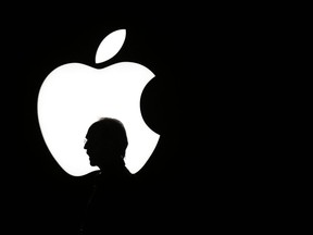 FILE - In this Sept. 9, 2015 file photo, a man walks past the Apple logo during a product display for Apple TV following an Apple event in San Francisco. Television is one of the few screens that has Apple hasn't conquered, but that may soon change. The world's richest company appears ready to set out to produce Emmy-worthy programming along the lines of HBO's "Game of Thrones" and Netflix's "Stranger Things."  (AP Photo/Eric Risberg, File)