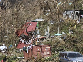 FILE - In this Sept. 23, 2017 photo, homes lay scattered after the passing of Hurricane Maria in Roseau, the capital of the island of Dominica. The U.N. humanitarian office has launched a $31.1 million emergency appeal for the hurricane-battered Caribbean island of Dominica which was hit by a category 5 storm on Sept. 18. The U.N. said Friday, Sept. 29 the appeal aims to provide emergency aid to 65,000 people from September to December 2017. It said $3 million was expected to be released later Friday from the U.N.'s Central Emergency Response Fund for Dominica. (AP Photo/Carlisle Jno Baptiste, File)