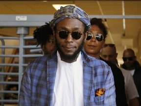 FILE - In this March 24, 2016 file photo, American actor and musician Yasiin Bey, also known as Mos Def, leaves the Bellville Magistrates' Court in Bellville, South Africa. Bey took the stage at the ONE Musicfest, a one-day music festival held in Atlanta, for what appeared to be the last performance of his career. (AP Photo/Schalk van Zuydam, File)