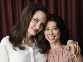 In this Sept. 11, 2017 photo, Angelina Jolie, left, director/co-writer of the film "First They Killed My Father: A Daughter of Cambodia Remembers," and co-writer/human rights activist Loung Ung pose for a portrait during the Toronto International Film Festival in Toronto. (Photo by Chris Pizzello/Invision/AP)