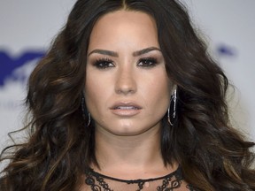 FILE - In this Aug. 27, 2017 file photo, Demi Lovato arrives at the MTV Video Music Awards in Inglewood, Calif. Lovato says she's reached out to nonprofit organization Voto Latino to find out how she can help after President Donald Trump said he's rescinding DACA, a program protecting immigrants brought to the U.S. illegally as children. Lovato, who grew up in Dallas, also said she started a fundraiser to assist those affected by Hurricane Harvey.  (Photo by Jordan Strauss/Invision/AP, File)