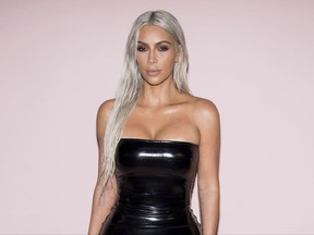 FILE - In this Sept. 6, 2017 file photo, Kim Kardashian West attends the Tom Ford show as part of NYFW Spring/Summer 2018 in New York.  Kardashian West is confirming that she and Kanye West are having a third child. She appears in a short video released Thursday for "Keeping Up With the Kardashians" where she is speaking with her sister Khloe on a video chat. At one point during the call, she tells her sister, "We're having a baby!" (Photo by Charles Sykes/Invision/AP, File)