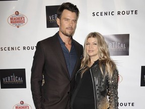 FILE - In this Aug. 20, 2013 file photo, actor Josh Duhamel, left and singer Fergie arrive at the premiere of "Scenic Route" in Los Angeles. The actor and singer confirmed that they'd decided to split up earlier this year but kept the news quiet "to give our family the best opportunity to adjust." (Photo by Richard Shotwell/Invision/AP, File)