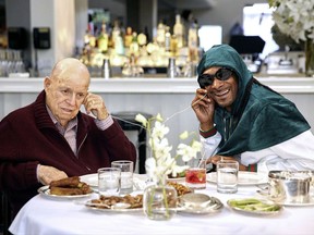 In this image released by AARP Studios, Don Rickles, left, and Snoop Dogg listen to music during an appearance on Rickles' 13-episode series "Dinner with Don." Rickles, who died in April of kidney failure at age 90, interviews celebrities such as Jimmy Kimmel, Snoop Dogg, Robert De Niro and Martin Scorsese at his favorite restaurants in Hollywood. The series can be seen on AARP's digital platform DinnerWithDon.com (Sean Costello/Dinner With Don/AARP Studios via AP)