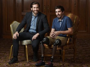 In this Sept. 10, 2017 photo, Jake Gyllenhaal, left, poses for portrait with Boston Marathon bombing survivor Jeff Bauman during the Toronto International Film Festival in Toronto. Gyllenhaal portrays Bauman in the film "Stronger." (Photo by Chris Pizzello/Invision/AP)