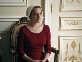 This image released by Hulu shows Elisabeth Moss as Offred in a scene from, "The Handmaid's Tale."The program is nominated for an Emmy Award for outstanding drama series. The Emmy Awards ceremony, airing Sept. 17 on CBS, will be hosted by Stephen Colbert. (George Kraychyk/Hulu via AP)