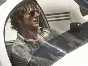 This image released by Universal Pictures shows Tom Cruise as Barry Seal in a scene from, "American Made."  (David James/Universal Pictures via AP)
