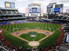 People walk on the field after a press conference about the NHL Winter Classic at Citi Field in New York, Friday, Sept. 8, 2017. The New York Rangers and Buffalo Sabres will play in the Winter Classic at City Field on Jan. 1, 2018. (AP Photo/Frank Franklin II)