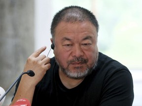 FILE - In this July 13, 2016 file photo, Chinese artist and activist Ai Weiwei speaks during a press conference at the exhibition 'translocation - transformation' at the Museum of contemporary art in Vienna, Austria. Ai is getting some local opposition to his planned public art project in New York City. The New York Times reports the Washington Square Association is protesting Ai's proposed installation in the park's archway. (AP Photo/Ronald Zak, File)