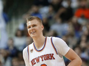 FILE- In this Jan. 25, 2017, file photo, New York Knicks' Kristaps Porzingis of Latvia jogs up court smiling during an NBA basketball game against the Dallas Mavericks in Dallas. Several NBA stars changed addresses during the offseason, creating opportunities for players to step into bigger roles on several rosters including Porzingis. (AP Photo/Tony Gutierrez, File)