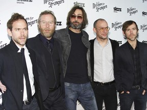 FILE- In this March 25, 2014, file photo, from left, Bryce Dessner, Matt Berninger, Bryan Devendorf, Scott Devendorf, and Aaron Dessner of The National band arrive at the LA Special Screening of "Mistaken For Strangers" at the Shrine Auditorium in Los Angeles. With "Sleep Well Beast," the band's seventh studio album and first in four years, The National revives the distinctive vibe that led it to the forefront of 21st century arena rock bands. Familiar or not, these guys are good at what they do. (Photo by Annie I. Bang /Invision/AP, File)