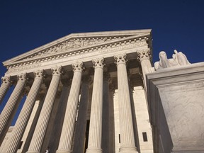 FILE- This April 4, 2017, file photo, shows the Supreme Court Building is seen in Washington. The Supreme Court is allowing the Trump administration to maintain its restrictive policy on refugees. The justices on Tuesday, Sept. 12, agreed to an administration request to block a lower court ruling that would have eased the refugee ban and allowed up to 24,000 refugees to enter the country before the end of October. (AP Photo/J. Scott Applewhite, File)