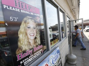 FILE - In this Sept. 9, 2014 file photo, a poster offering a reward for information in the disappearance of Holly Bobo, is displayed in a store window in Parsons, Tenn. The case against Zachary Adams, a man charged with kidnapping, raping and killing Bobo is "absolutely full of holes" and based on "non-evidence," a defense attorney said Thursday, Sept. 21, 2017. Jennifer Thompson delivered closing arguments Thursday in the trial of Adams in Savannah. (AP Photo/Mark Humphrey, File)