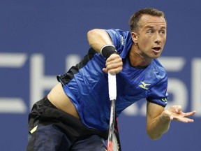 Philipp Kohlschreiber, of Germany, follows through on a serve in a fourth-round match against Roger Federer, of Switzerland, at the U.S. Open tennis tournament in New York, Monday, Sept. 4, 2017. (AP Photo/Kathy Willens)