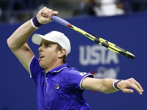 Sam Querrey, of the United States, follows through on a shot in the first set of his fourth round match against Mischa Zverev, of Germany, at the U.S. Open tennis tournament in New York, Sunday, Sept. 3, 2017. (AP Photo/Kathy Willens)