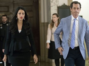 Former U.S. Rep. Anthony Weiner, right, and his estranged wife Huma Abedin leave court, Wednesday, Sept. 13, 2017, in New York. The couple appeared before a New York City judge to ask for privacy in their divorce case.  (AP Photo/Mary Altaffer)