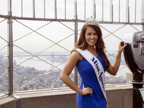 Newly-crowned Miss America 2018 Cara Mund poses for photographers on the 86th Floor Observation Deck of the Empire State Building, Tuesday, Sept. 12, 2017, in New York. The 23-year-old from North Dakota won the crown Sunday night after saying in an onstage interview that President Donald Trump was wrong to pull the United States out of the Paris climate accord (AP Photo/Mary Altaffer)