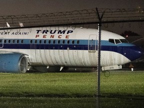 FILE- In this Oct. 27, 2016 file photo, Republican vice presidential candidate, Indiana Gov. Mike Pence's campaign airplane sits partially on the tarmac and the grass after sliding off the runway while landing at LaGuardia airport in New York. A report by the National Transportation Safety Board released on Thursday, Sept. 21, 2017, held the pilots responsible for the aircraft over-running the runway. (AP Photo/Mary Altaffer, File)