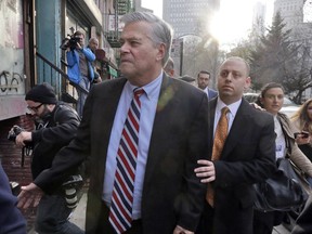 FILE - In this Dec. 11, 2015 file photo, former New York state Senate leader Dean Skelos, left, and his son Adam Skelos leave federal court, in New York. Skelos and his son were convicted of federal extortion charges, but they have been granted new trials in their corruption case. A federal appeals court said Tuesday Sept. 26, 2017, the jury was wrongly instructed. That's in light of a recent Supreme Court ruling narrowing the definition of what it takes to convict a public official. (AP Photo/Richard Drew, File)